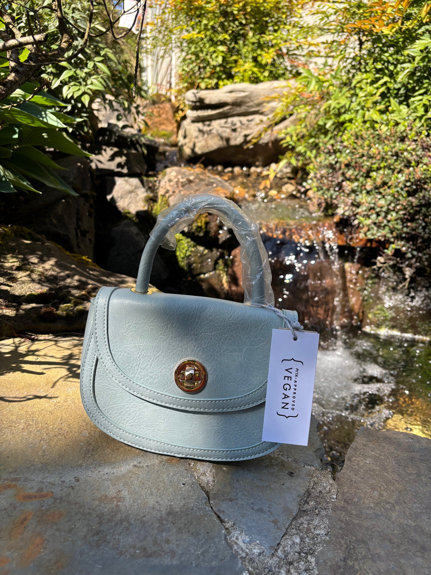 Baby blue colored handbag/shoulderbag with straps inside purse