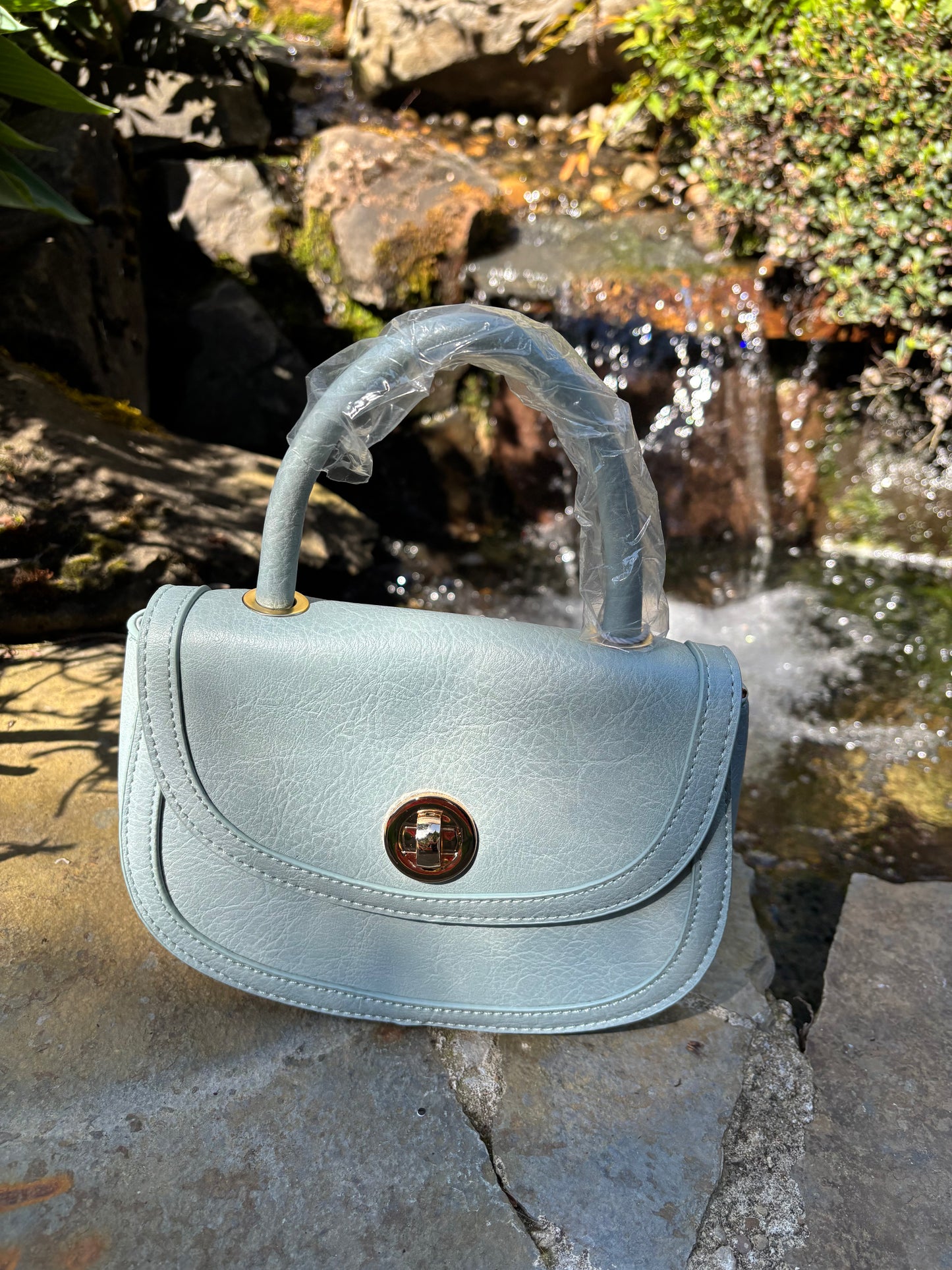 Baby blue colored handbag/shoulderbag with straps inside purse