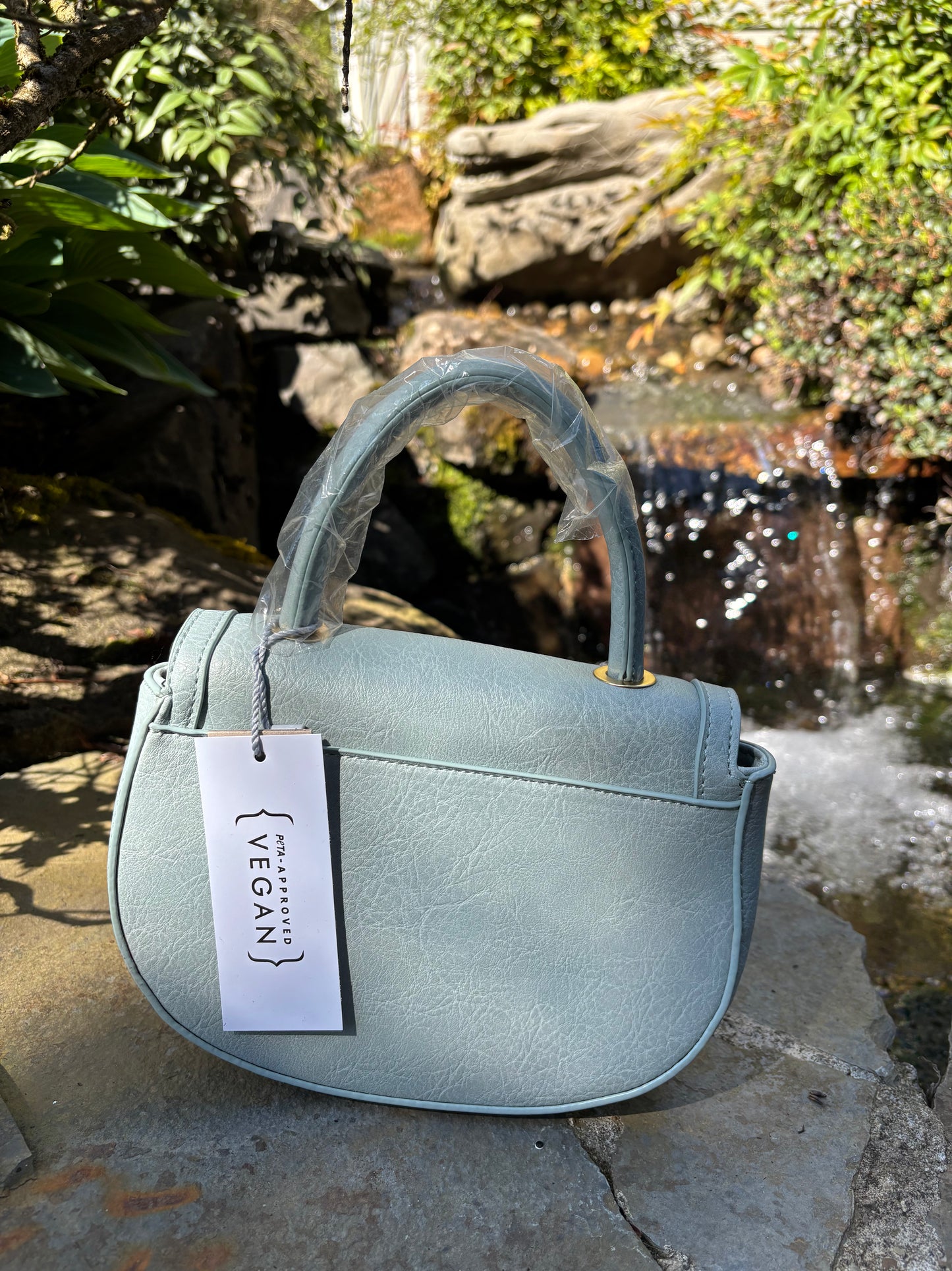 Baby blue colored handbag/shoulderbag with straps inside purse